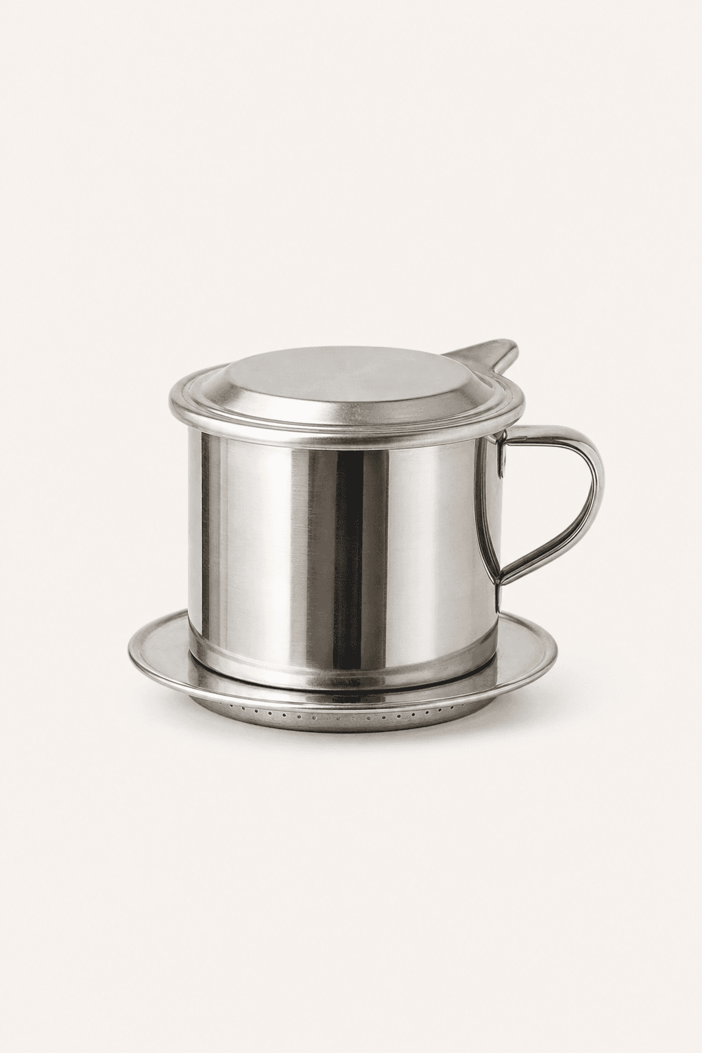 Vietnamese coffee dripper on a warm off-white background